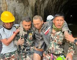 Rescuers carry a survivor out of a tunnel at the Trishuli-3A hydropower project in Nepal.