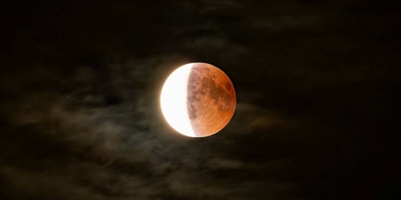 Phases of a partial lunar eclipse showing the moon transitioning from full to a darkened, coppery color.