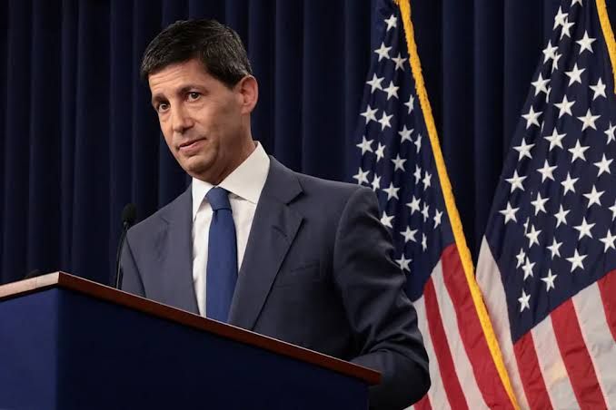 Federal Reserve Chairman Kevin Warsh speaking at a podium during a press conference about monetary policy.