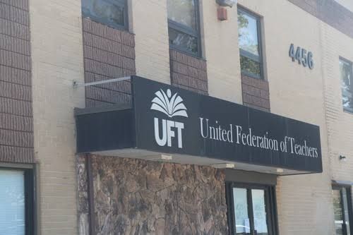 NYC paraprofessionals gathering outside a city office to discuss pension recalculation notices.