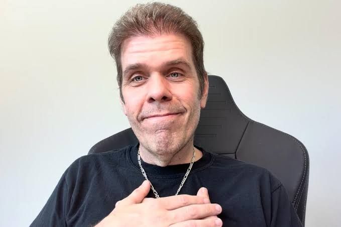 Perez Hilton lying in a hospital bed wearing a nasal cannula while recovering from his injuries.