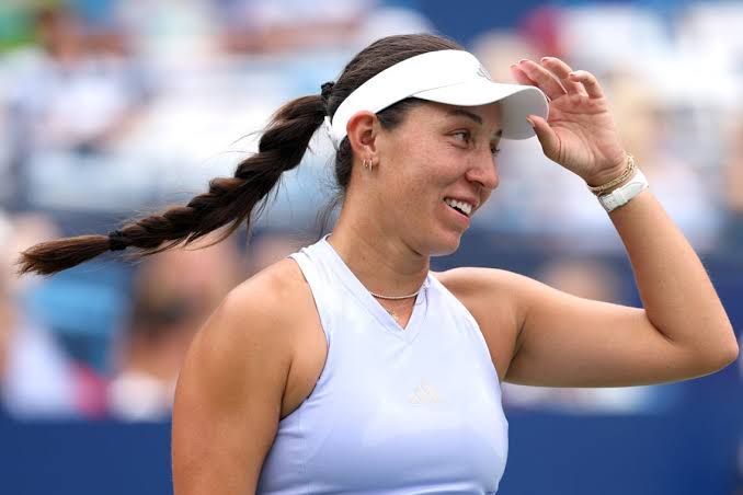 Jessica Pegula holds a tennis ball and racket during a match at the Washington Open.