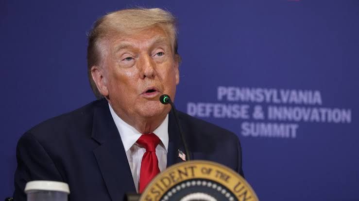 President Trump speaking at a White House podium regarding allegations of Chinese election interference.