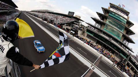 Kyle Larson stands near his race car at Indianapolis Motor Speedway during a previous Brickyard 400 event.