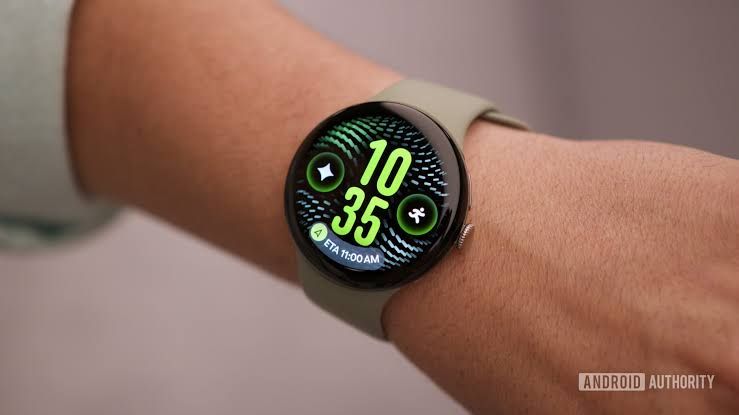 Close up of a Google Pixel Watch 5 display showing the At a Glance widget with date and temperature info.