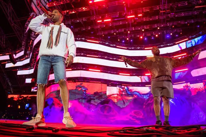 Kid Cudi and Kanye West performing together on stage during a concert at Soldier Field in Chicago.