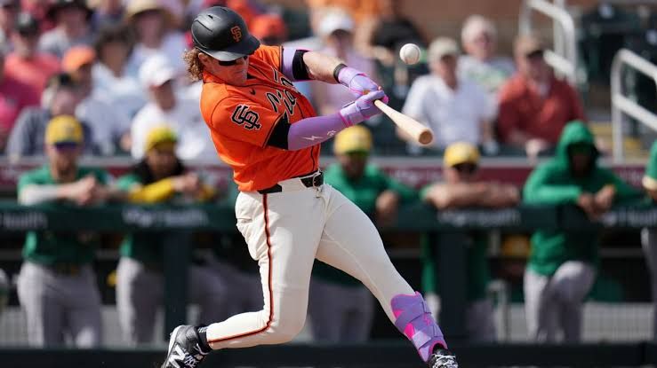 Harrison Bader in his San Francisco Giants jersey walking on the field during a game.