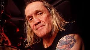 Iron Maiden drummer Nicko McBrain standing during a public appearance to discuss his band career and new book.
