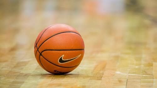 A portrait of Jheney Wallace in her basketball uniform standing on the court.