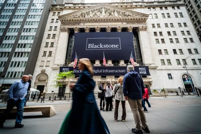 Blackstone headquarters signage visible in a glass-fronted financial building in Manhattan.