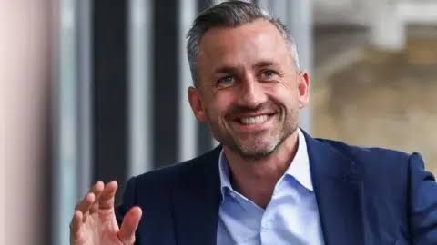 Ulrich Siegmund waving at a press conference following the AfD election results in Saxony-Anhalt.