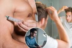 Shirtless man injecting testosterone into his bicep as part of hormone replacement therapy.