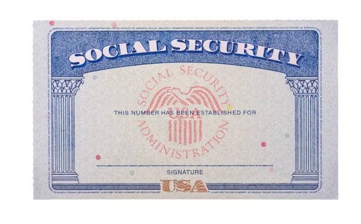 A close-up of a Social Security card on a wooden surface representing federal retirement benefits.