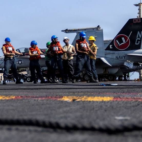 U.S. Navy sailors perform refueling operations on the flight deck of the USS Abraham Lincoln in the Middle East.