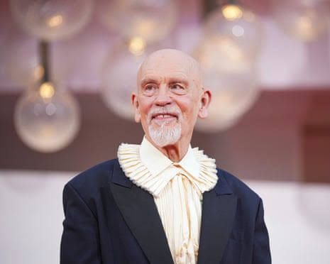 John Malkovich wearing a dark suit at a film festival premiere.