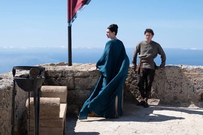 Anne Hathaway and Tom Holland in a dramatic scene from the film The Odyssey.