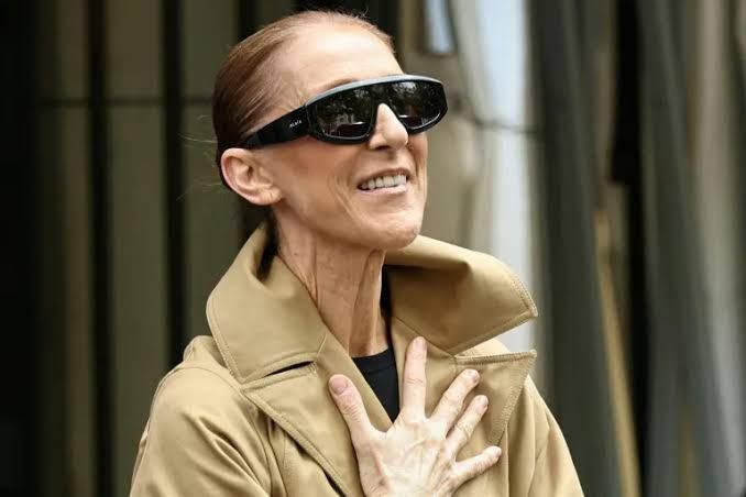 Celine Dion smiling and waving to fans in Paris ahead of her scheduled concert residency opening night.