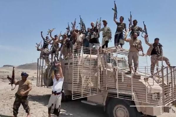 Houthi fighters standing on a military vehicle in Yemen's Taiz province, following recent regional escalations.