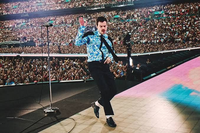 Harry Styles performs onstage in a blue suit during the Together Together tour in São Paulo.