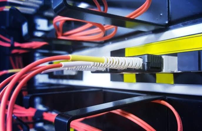 Fiber optic cables bundled together in a close-up shot representing high-speed internet connectivity.
