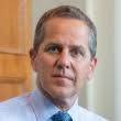 Federal Reserve Governor Michael Barr speaking at a podium during a conference about economic policy.
