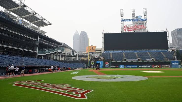 The Cleveland Guardians and Pittsburgh Pirates teams on the field with hazy conditions before a scheduled game.