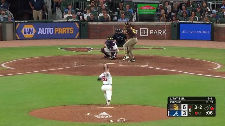 Fernando Tatis Jr. following through on a 474-foot home run swing at Truist Park during a game against the Braves.