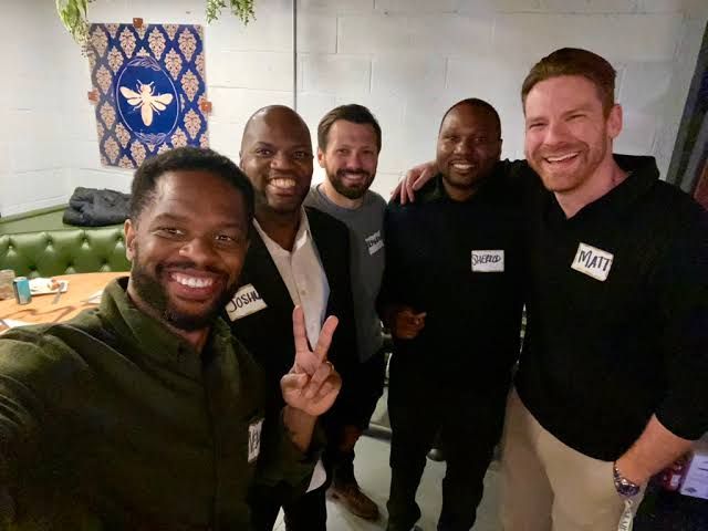 Vernon Foster and a group of local startup founders seated together at a dinner event discussing business growth.