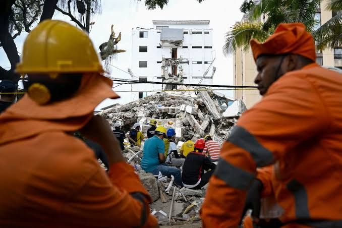 Emergency personnel navigate debris in a Colombian city following the 7.4 magnitude earthquake.