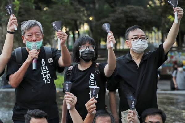 Pro-democracy activists Lee Cheuk-yan and Chow Hang-tung at a 2020 vigil in Victoria Park, Hong Kong.