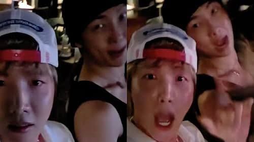 BTS members j-hope and RM stand backstage during a music event.