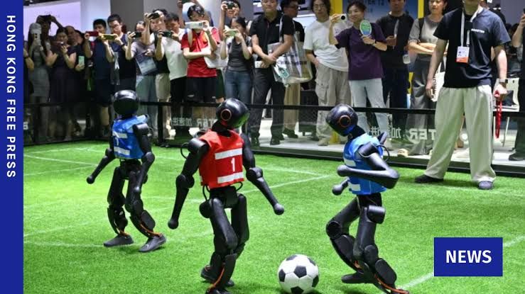 Humanoid robots playing football on a field during the World Artificial Intelligence Conference in Shanghai.
