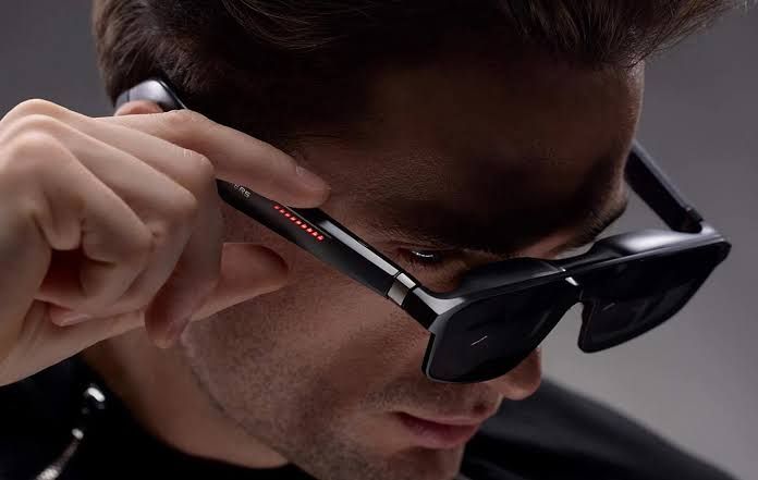 ASUS ROG Xreal R1 gaming glasses displayed alongside the ROG Control Dock on a clean tech product table.
