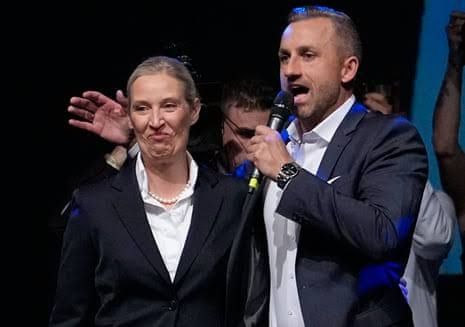 Ulrich Siegmund and Alice Weidel stand together at a podium addressing supporters after the Saxony-Anhalt election.