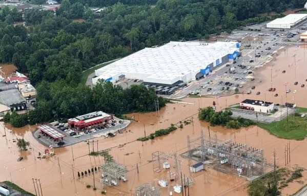 Aerial view of extensive flooding and debris surrounding damaged homes in Buckhannon, West Virginia.