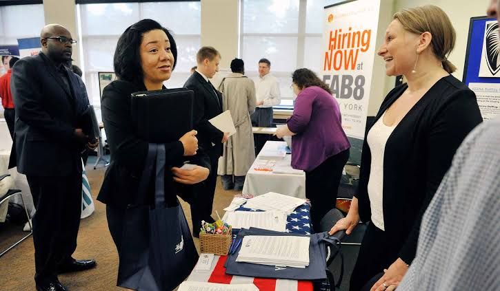 A job seeker talks to an employer representative at a professional job fair event in Saratoga Springs.