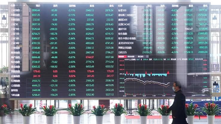 A busy trading floor at the Shanghai Stock Exchange showing electronic boards and financial professionals.