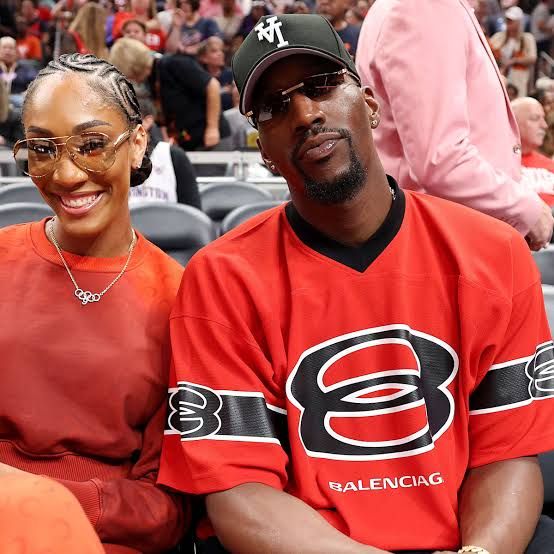 Bam Adebayo and A'ja Wilson standing together during a public event while discussing their relationship status.