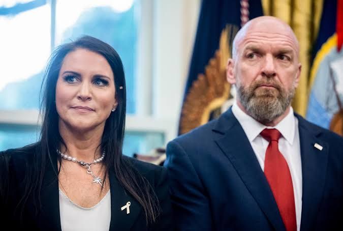 Triple H and Stephanie McMahon appearing together at a formal White House executive order event regarding technology.