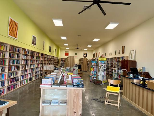 Owner Dante DiGenova setting up shelves in the new Northtown Books location before the September opening.