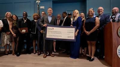 Capital One presents a 200,000 dollar check to support the Delaware Community Investment Venture Fund.