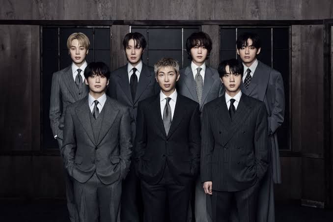 BTS members posing for a professional promotional press photograph for their album Arirang.