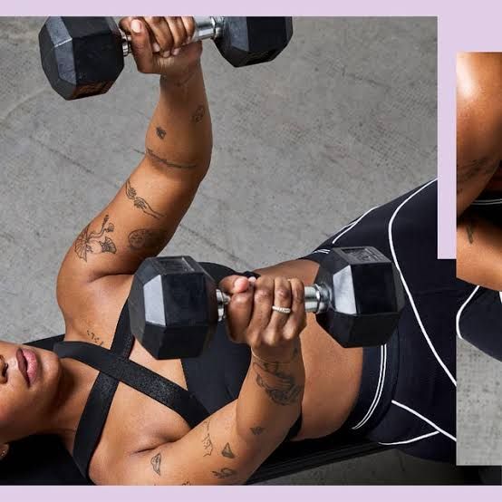 A woman lifting dumbbells while lying on a weight bench to demonstrate proper form for the Strong After 50 fitness plan.