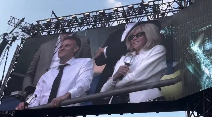 French President Emmanuel Macron and First Lady Brigitte Macron watch a BTS concert from the stands at Stade de France.