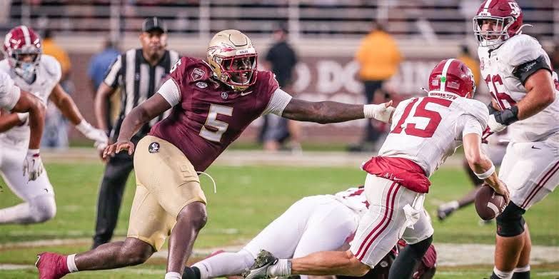 Florida State football defensive players participating in a drills session during the team preseason camp.