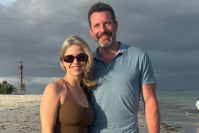 Amanda and Kristopher Karolkiewicz standing together in a portrait shared on social media.
