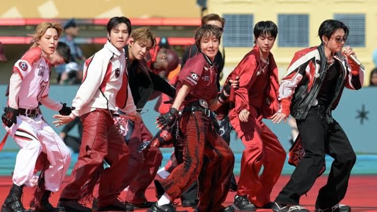 BTS performing on stage at the 2026 World Cup final at MetLife Stadium in New Jersey.