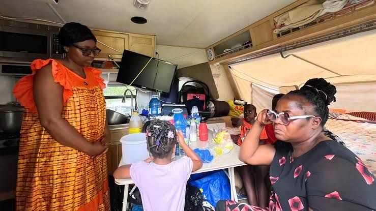 Armelle Foka standing near a trailer where her family is living in Montreal's Ahunstic neighborhood.