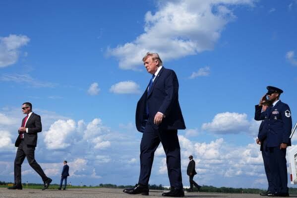 President Donald Trump walks away from Air Force One at a New Jersey airport after returning from Camp David.