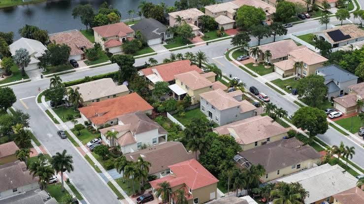 An aerial view of a residential neighborhood in Pembroke Pines, Florida, showcasing houses and streets in a suburban setting.